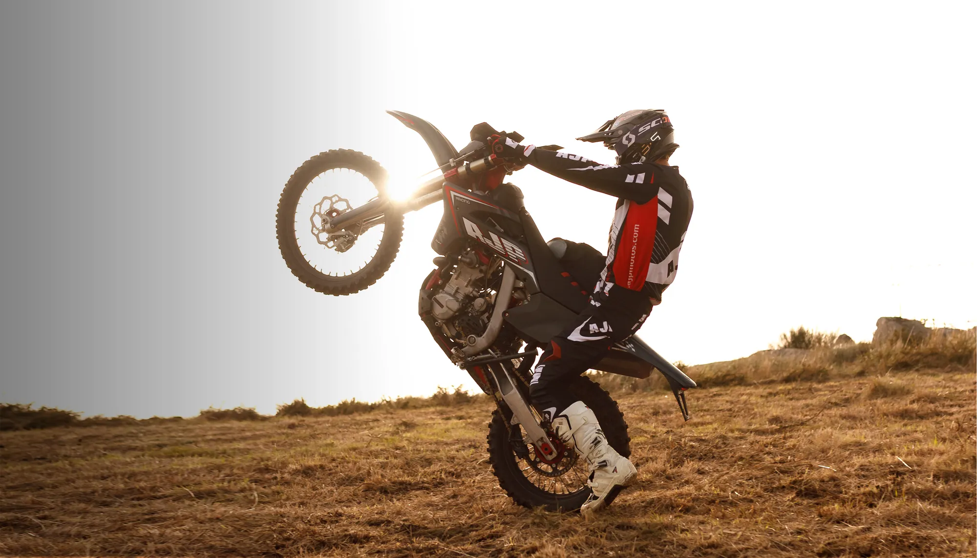 AJP PR7 rider lifting the front wheel